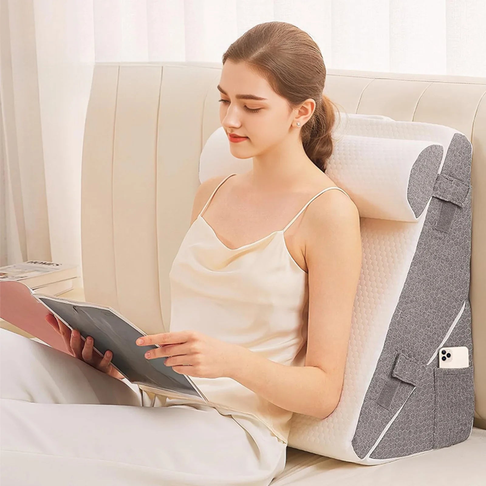 Woman using a backrest pillow while reading on a couch