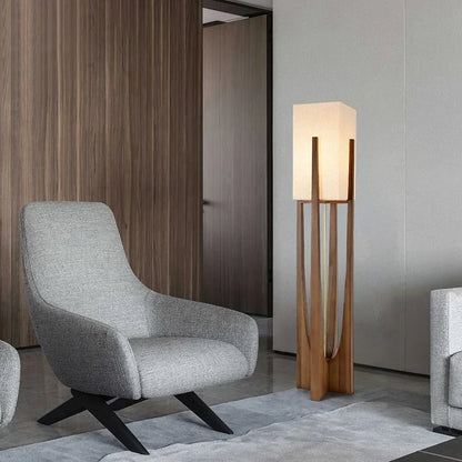 Modern gray armchair with a floor lamp in a stylish interior setting.