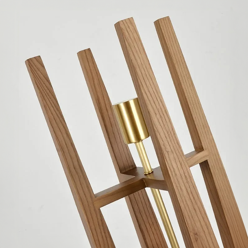 Wooden floor lamp body with gold accents on a light grey background