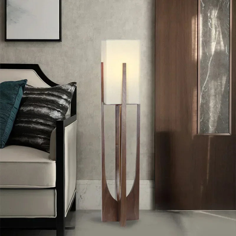 Modern floor lamp in a stylish room with a sofa and decorative pillows.