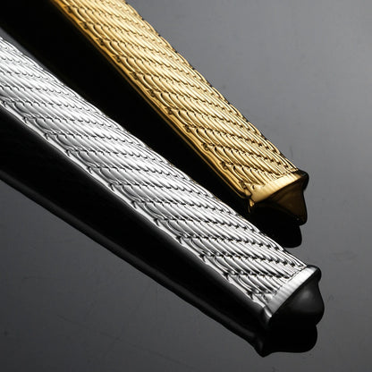 Close-up of a gold and silver textured belt buckle on a dark background