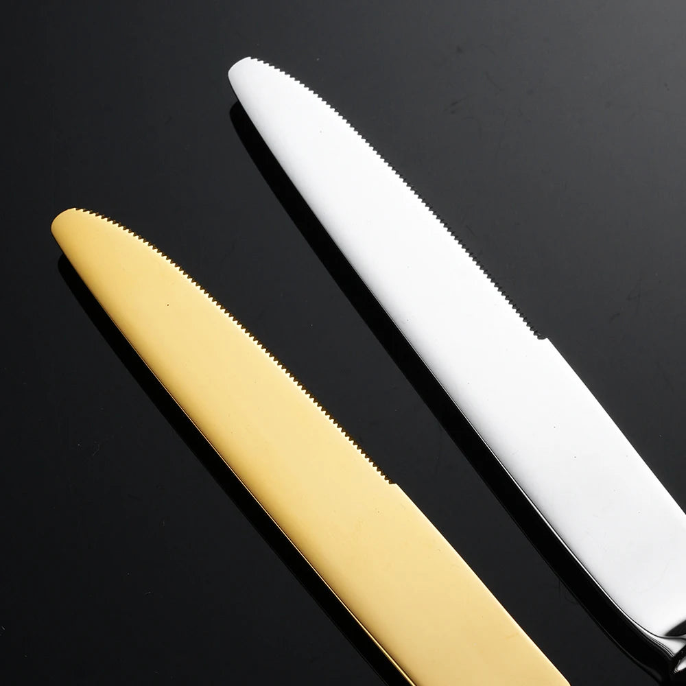 Gold and silver knives on a black background