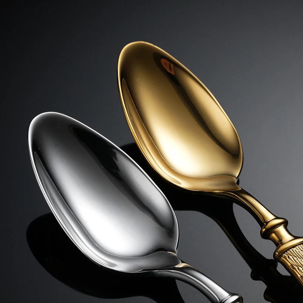 Gold and silver spoons on a dark background