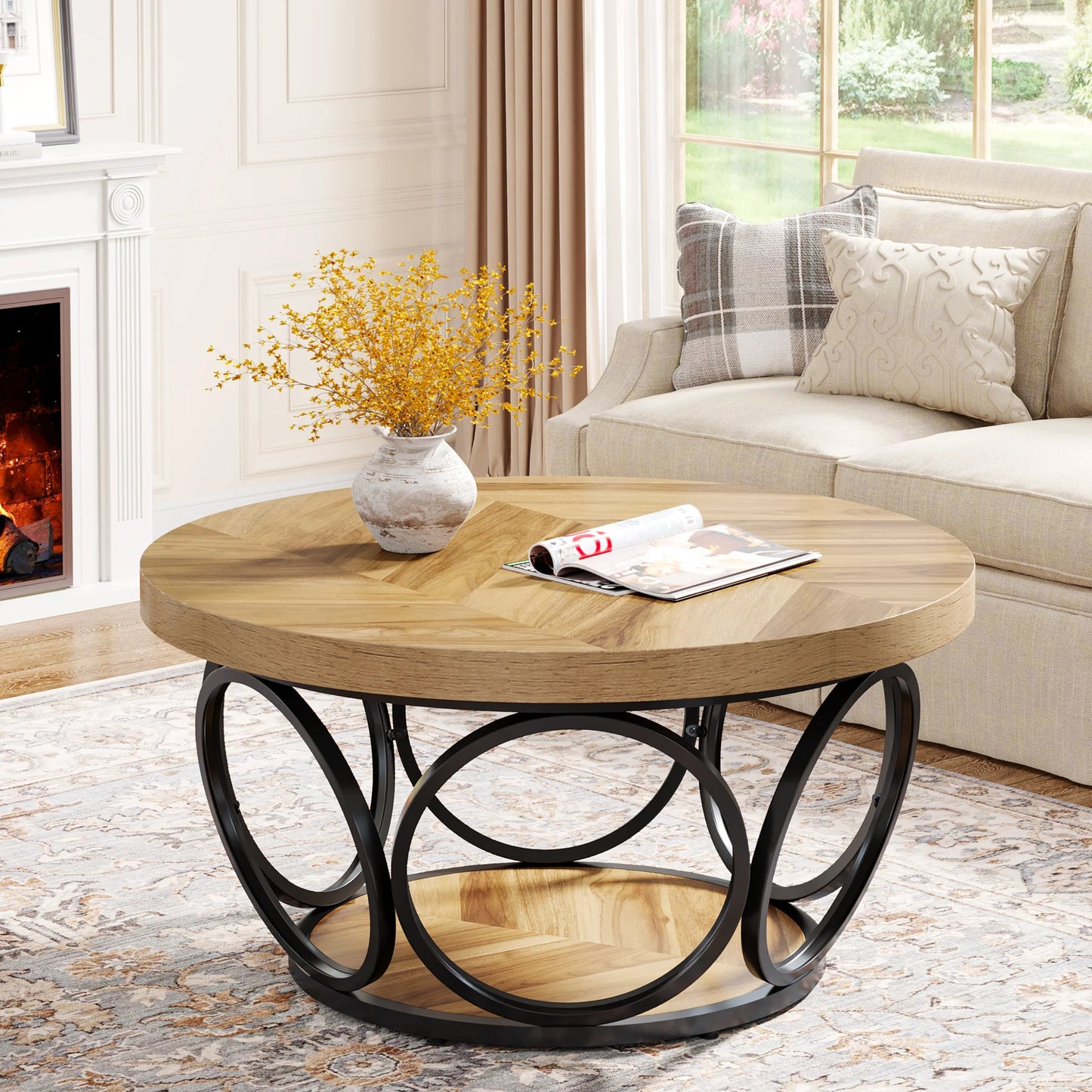 Round wooden coffee table with metal base in a living room setting.