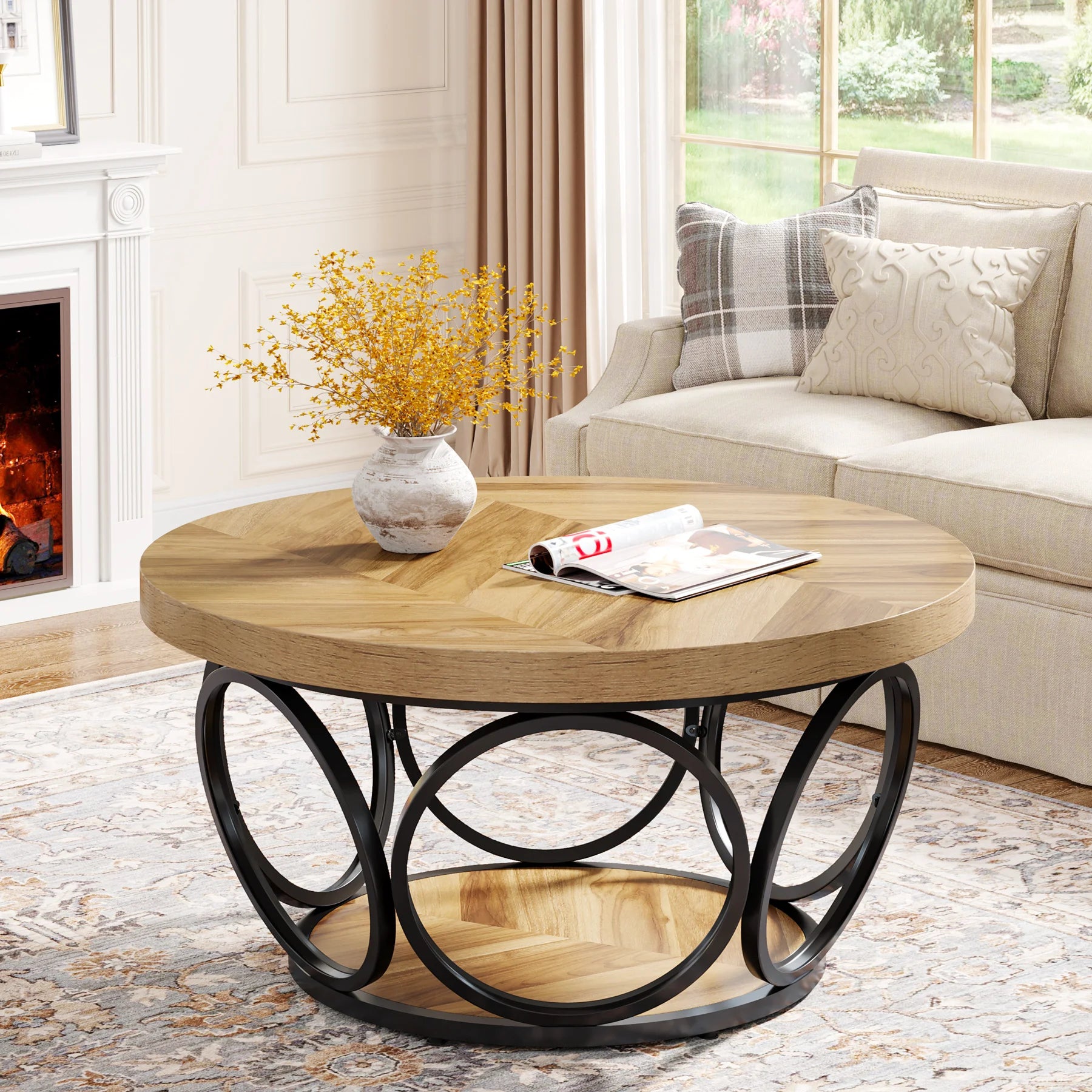Round wooden coffee table with metal base in a living room setting.