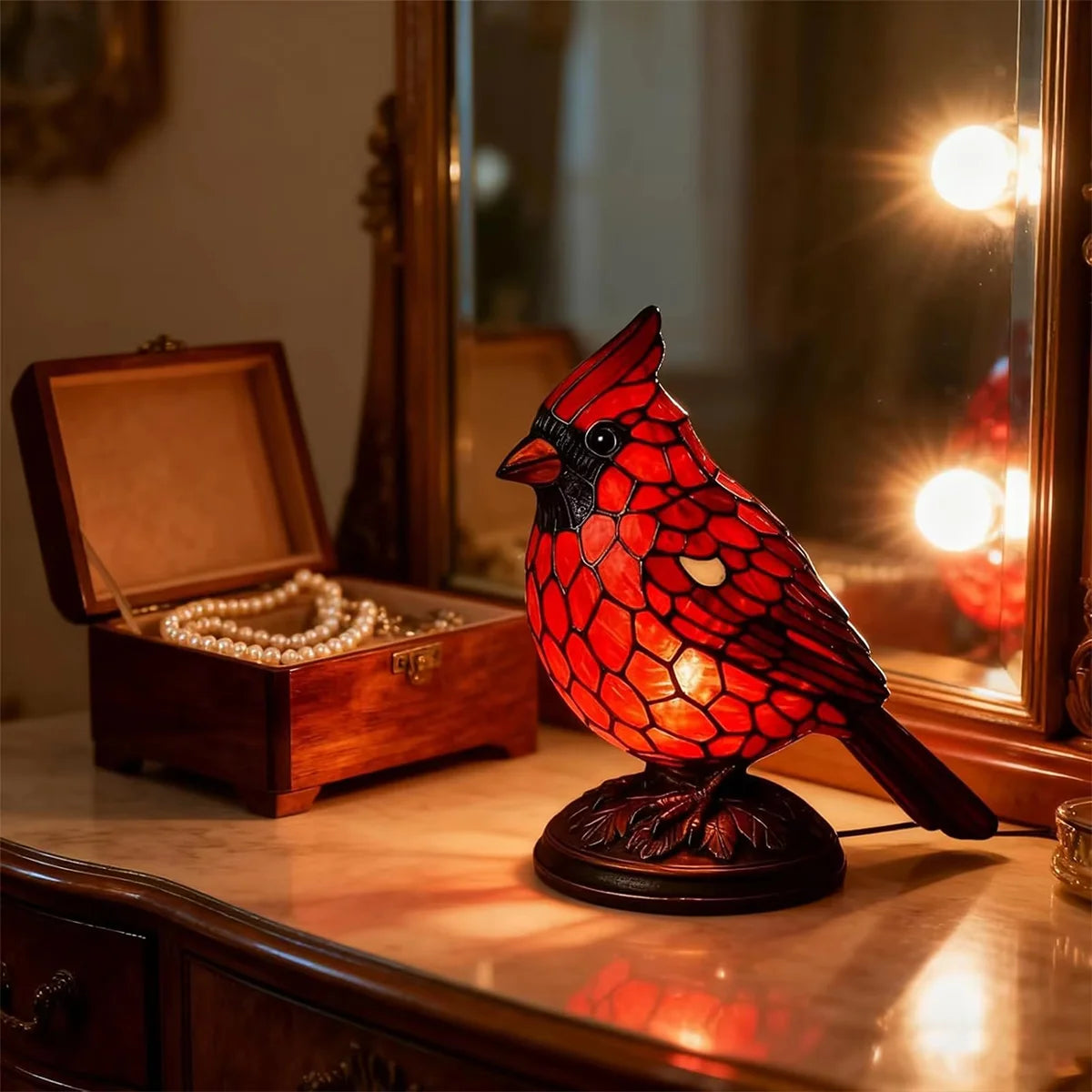 red cardinal decorative table lamp next to the jewelry box
