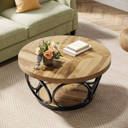 Round wooden coffee table with a vase of flowers and books in a living room setting.