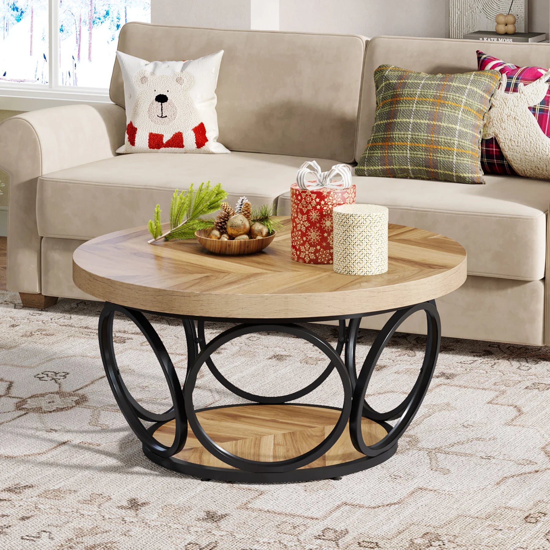 Round wooden coffee table with decorative items in a living room setting.