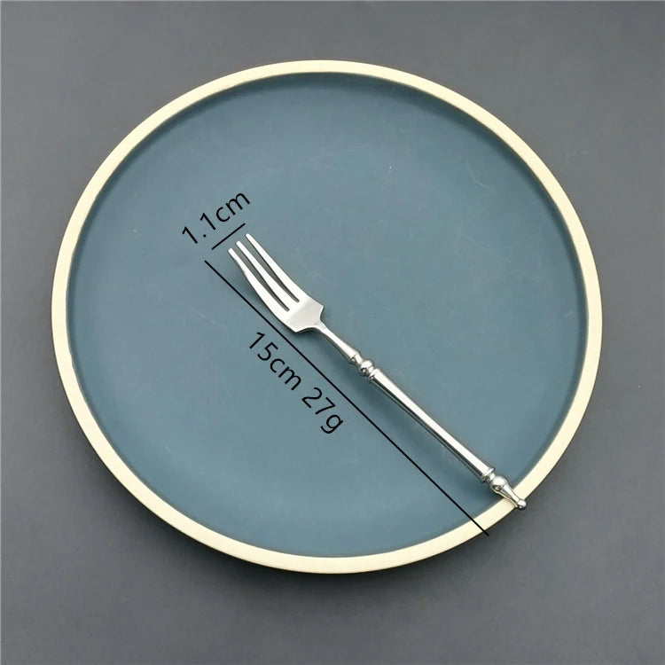 Teal plate with a fork for size comparison on a gray background