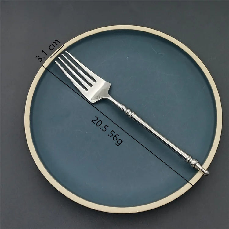 Silver fork on a blue plate with measurements indicated
